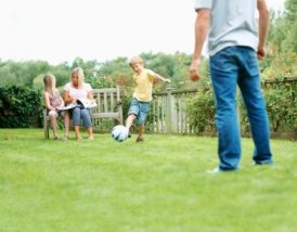 Portrait of a happy family enjoying vacation together at park